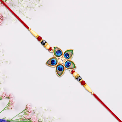 Star-shaped Designer Mor Pankh Rakhi by Wukusy, featuring intricate fashion design and detailed craftsmanship in vibrant colors.