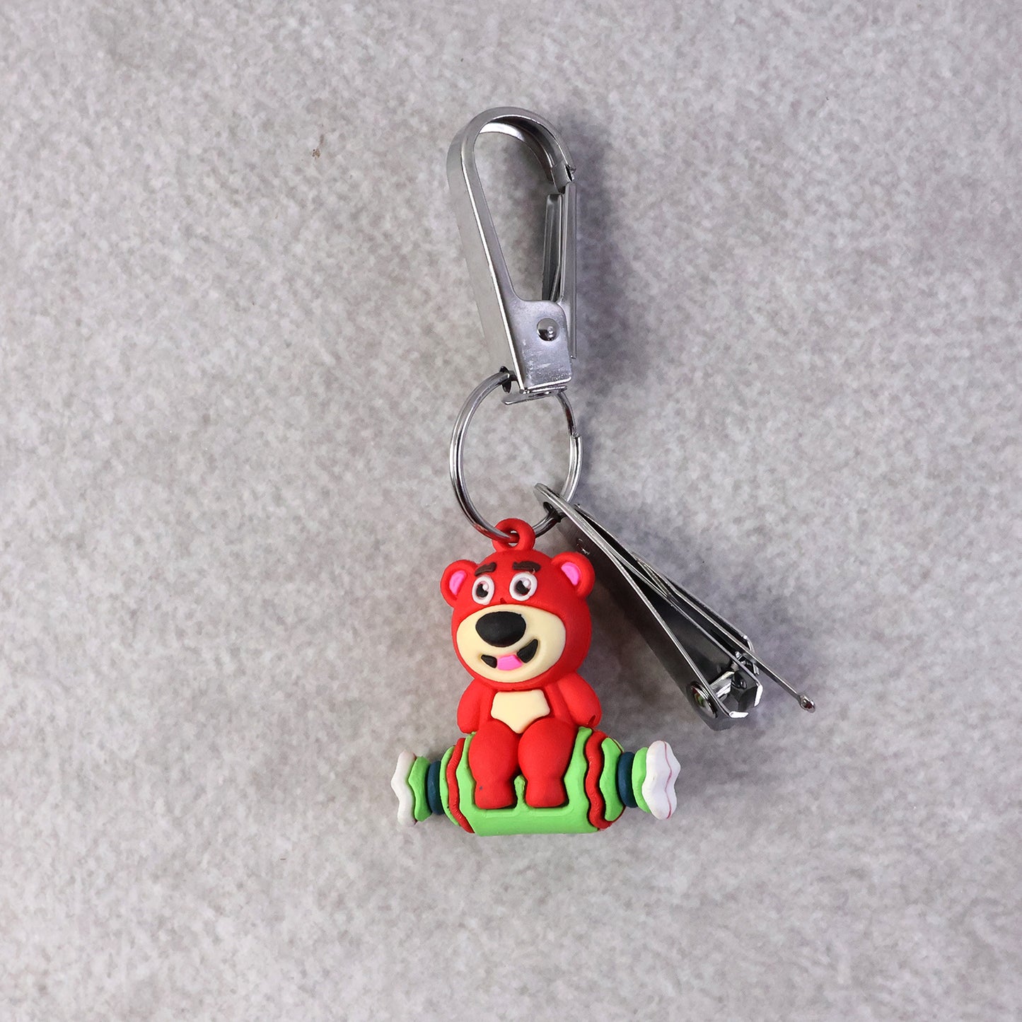 Wukusy cartoon nail cutter keychain with mini nail clipper featuring colorful mix design on a silver keyring.