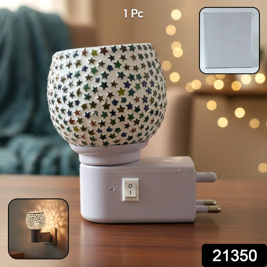 Wukusy decorative star pattern mosaic glass night lamp plugged into a wall socket, illuminating a cozy room with colorful glass design.