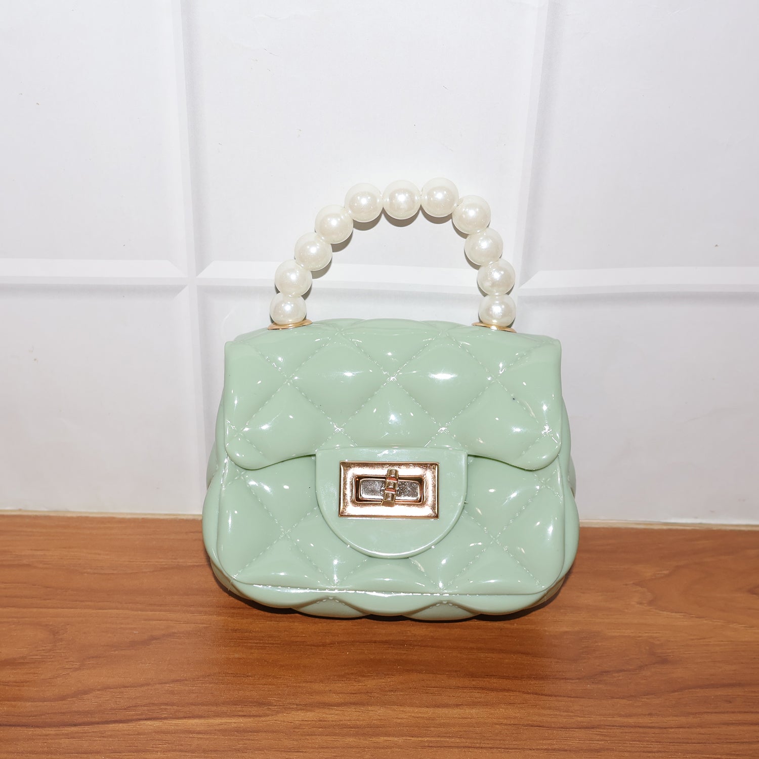 Wukusy elegant quilted mini handheld sling handbag with stylish design, compact size, and fashionable appearance.