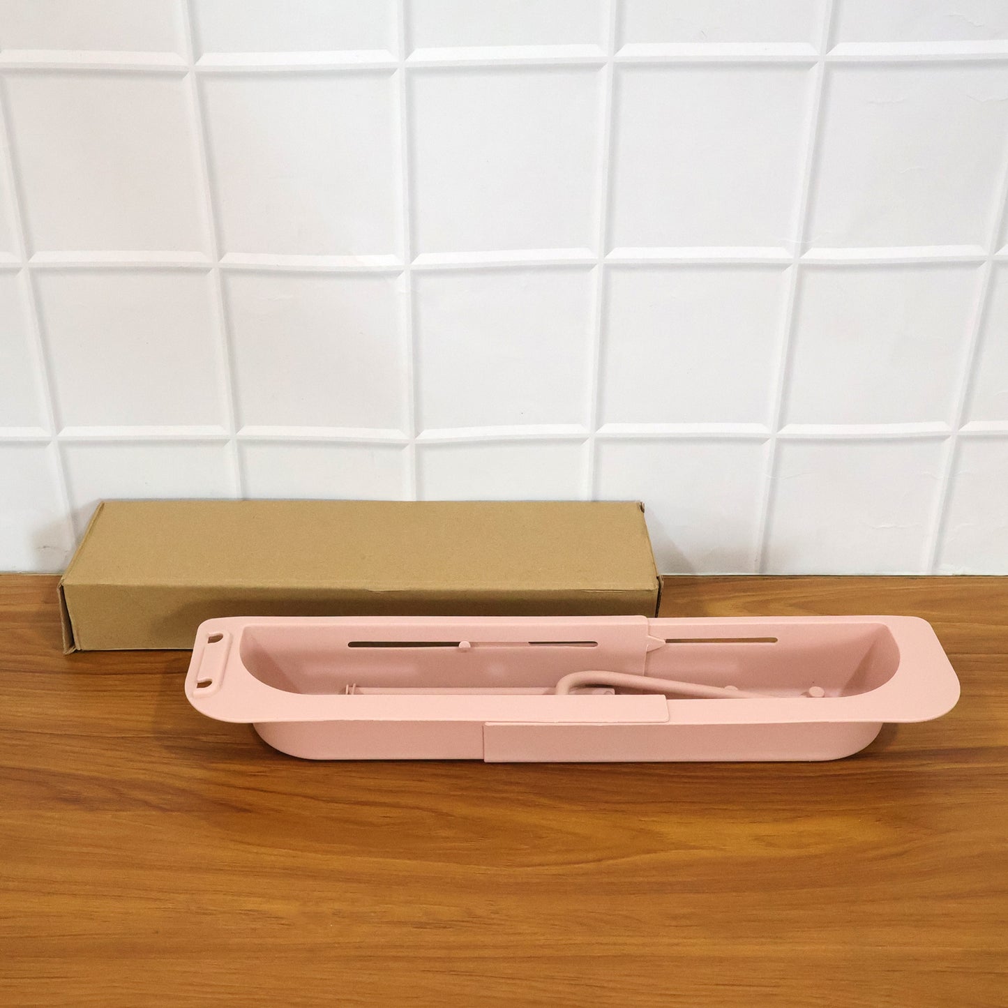 Wukusy kitchen sink organizer rack with towel holder and drain tray, designed to keep utensils and sponges organized.