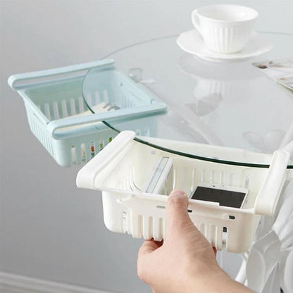 Wukusy 2336 expandable adjustable multipurpose fridge storage basket with handles for organizing fruits, vegetables, and kitchen items.