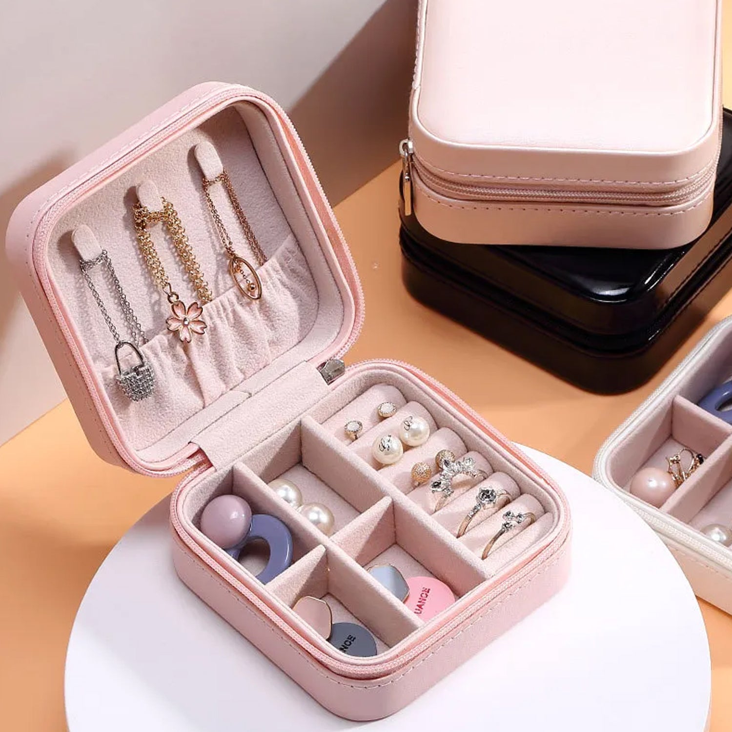 Wukusy mini portable jewelry box for women, leather organizer holding rings, earrings, pendants, and necklaces for travel and storage