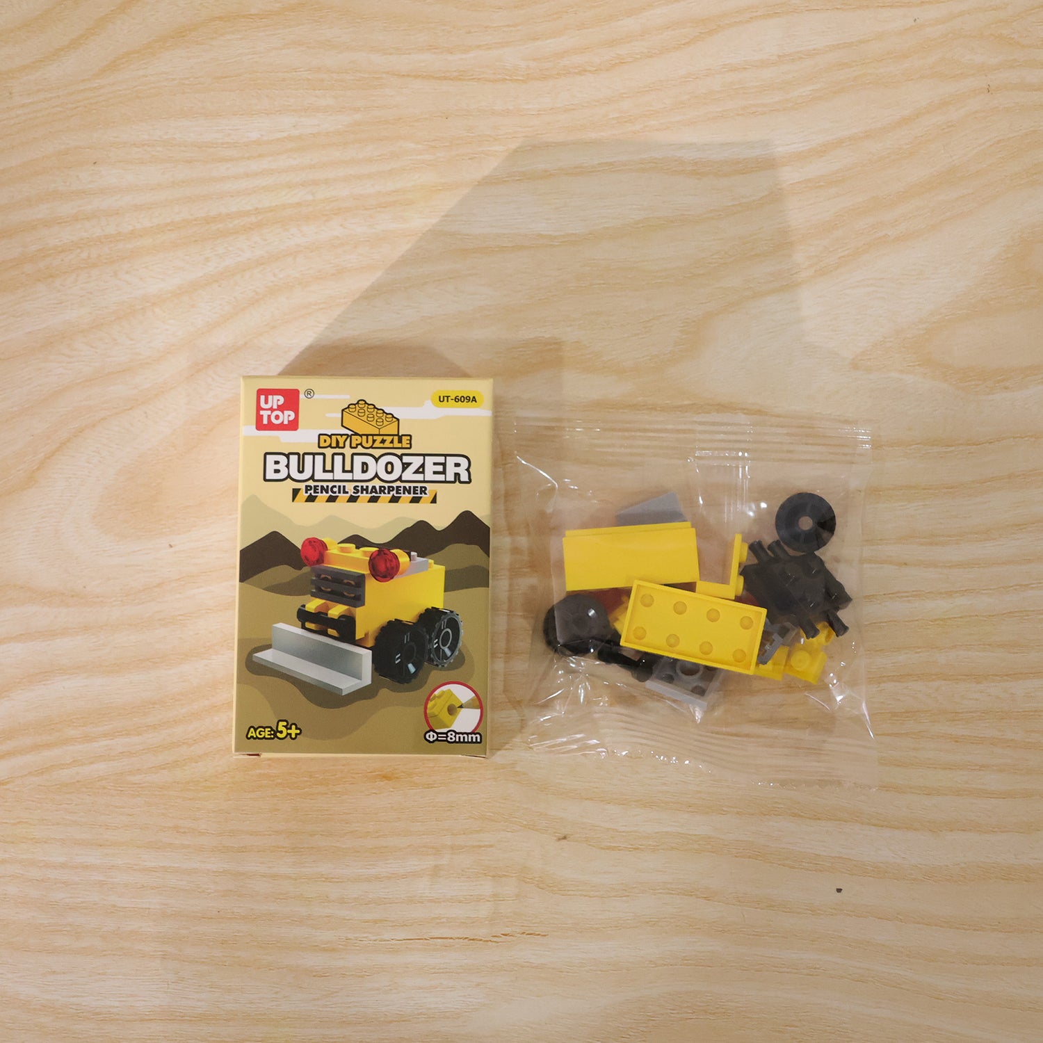 Wukusy cute bulldozer pencil sharpener toy on a desk, featuring a colorful, interactive design for fun and creativity.