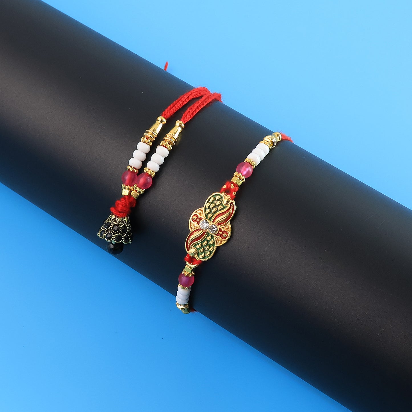 Elegant pink beaded Bhabhi Lumba Rakhi with butterfly design and stone work, featuring tassels, by Wukusy.