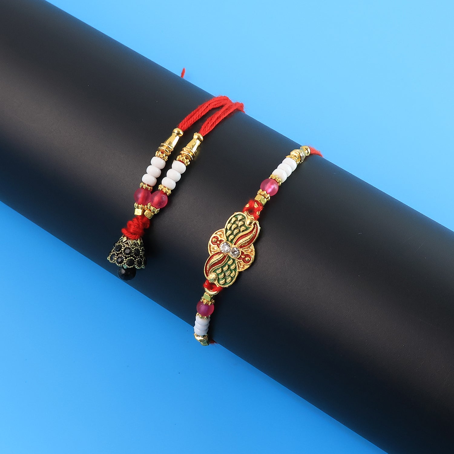 Elegant pink beaded Bhabhi Lumba Rakhi with butterfly design and stone work, featuring tassels, by Wukusy.