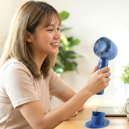 Wukusy rechargeable mini handheld fan with foldable design and ergonomic grip, ideal for personal cooling and outdoor use.