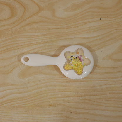 Wukusy cute star design kids hair brush with soft bristles for gentle detangling, shown in a child's hand.