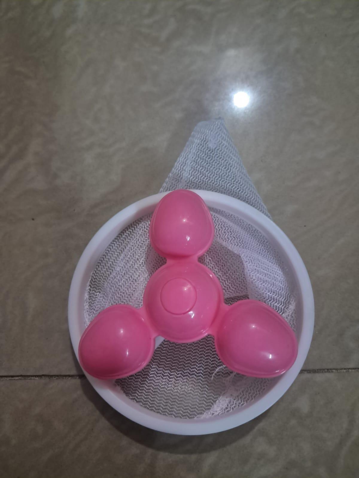 Washing machine hair removal ball accessory by 21334, designed to trap lint and hair during laundry.