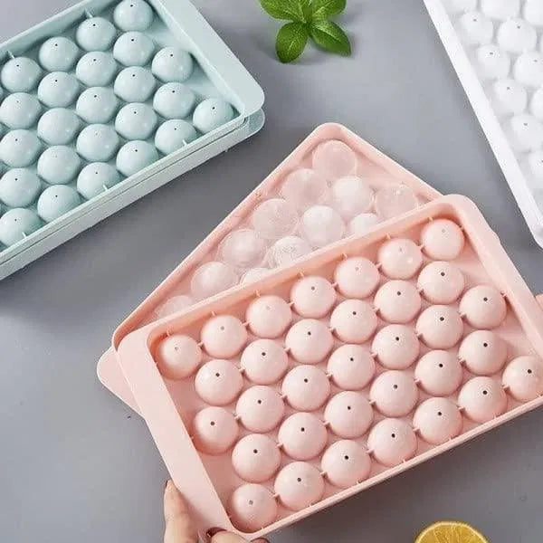 Reusable plastic round ice cube tray by 22927, flexible mold for making multiple clear ice cubes in a kitchen or bar setting.