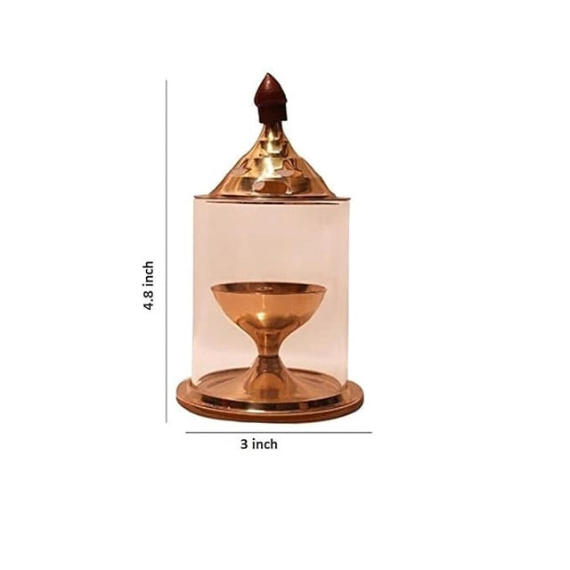 Brass and glass Akhand Deep Diya with cover for puja, traditional oil lamp for spiritual rituals and worship ceremonies.