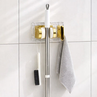 Wall mounted broom and mop holder by Wukusy with strong grip clips for secure storage, shown holding a broom and mop.