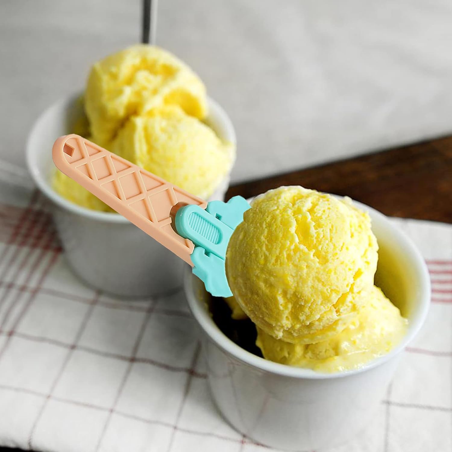 Two Wukusy plastic watermelon ice cream spoons with triggers, ideal for summer parties and food serving.