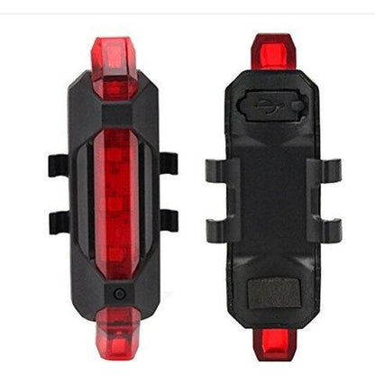 Wukusy 1561 rechargeable bicycle front waterproof LED light in red, mounted on a bike handlebar for visibility and safety