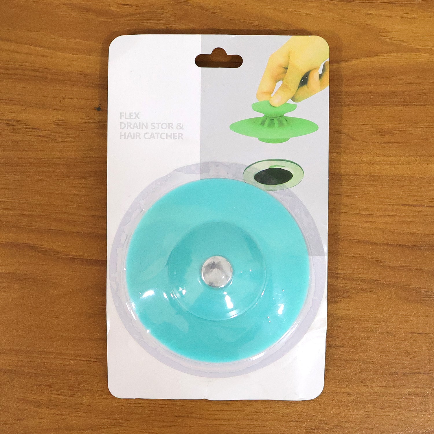Flexible silicone sink drain cover hair catcher strainer by Wukusy, showing a close-up of the black drain cover in a kitchen sink.