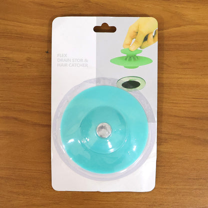 Flexible silicone sink drain cover hair catcher strainer by Wukusy, showing a close-up of the black drain cover in a kitchen sink.