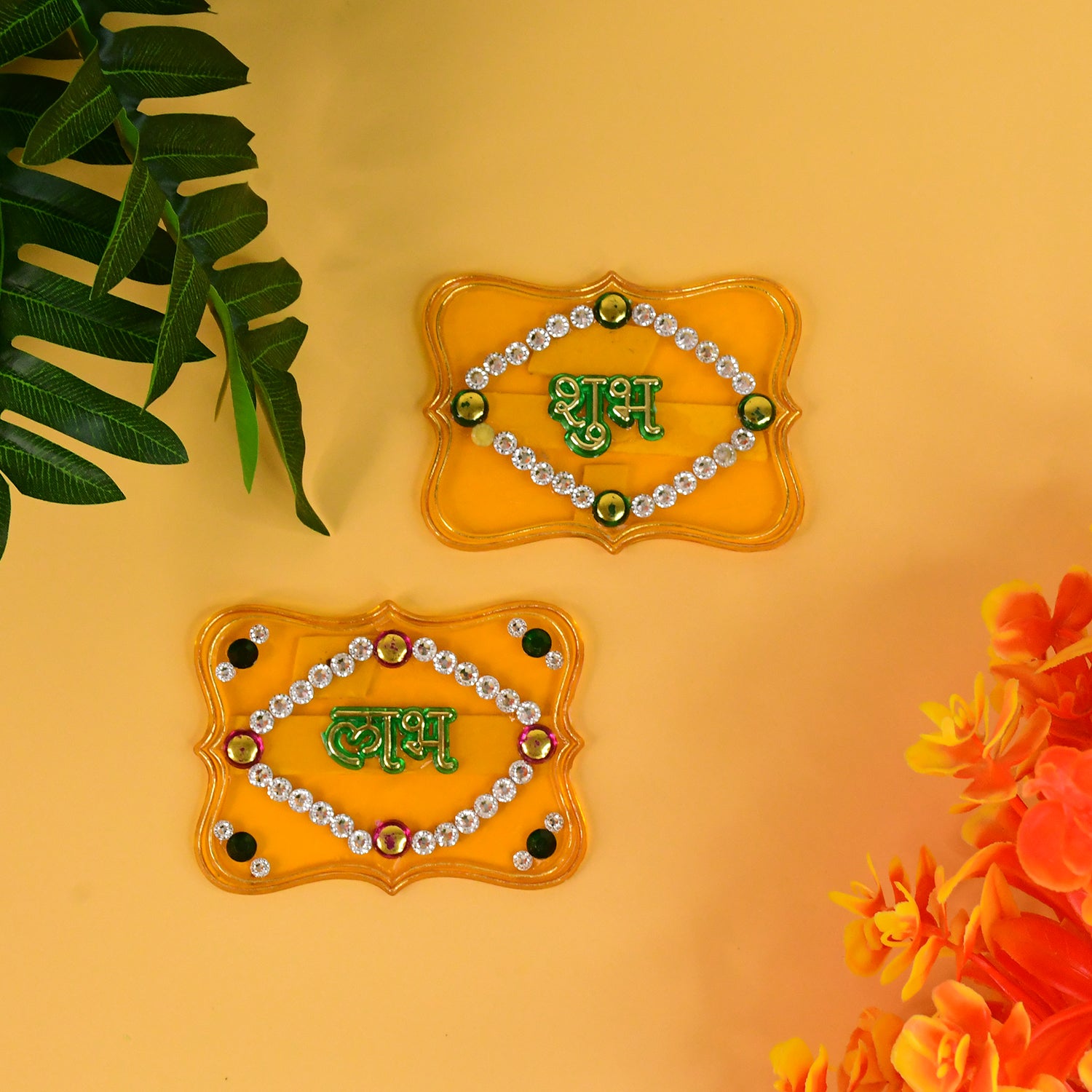 Two Wukusy Shubh Labh decorative wall hangings for home decor, featuring traditional Indian symbols on intricate designs.