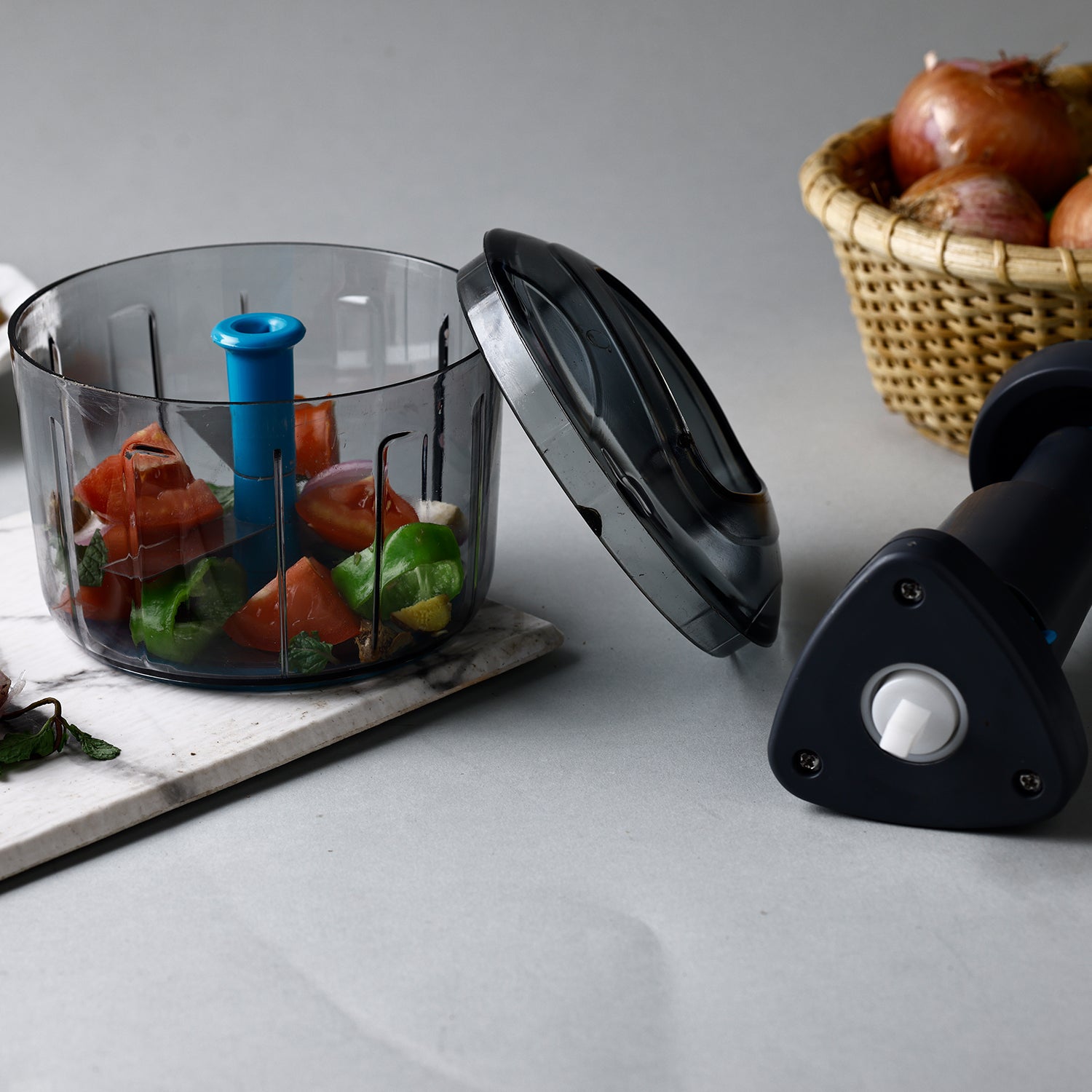 Wukusy Ganesh Bingo Lock-unlock push chopper in 725ml with green lid, top view showing chopping blade and container.