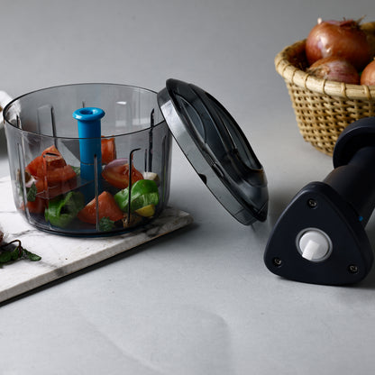 Wukusy Ganesh Bingo Lock-unlock push chopper in 725ml with green lid, top view showing chopping blade and container.
