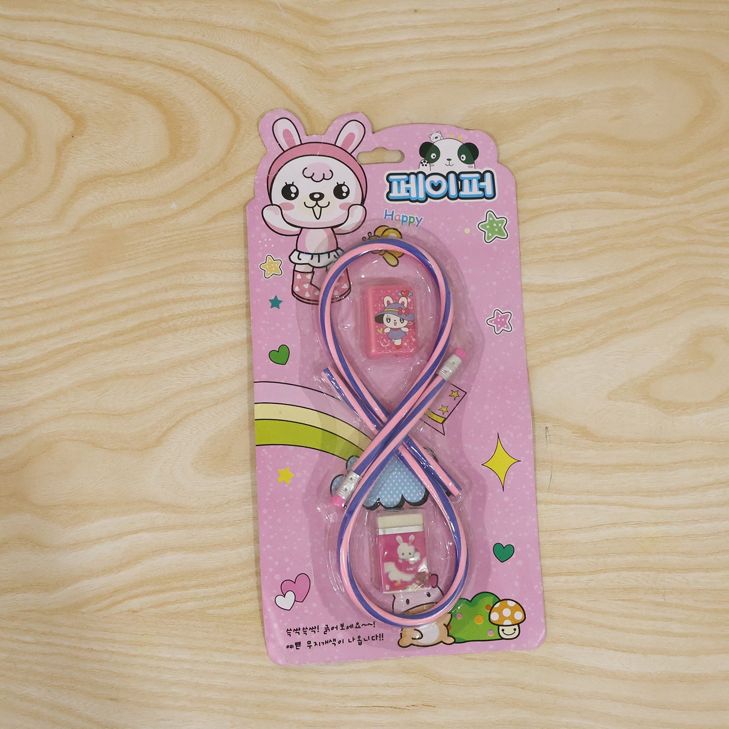 Kids school stationery set by Wukusy with flexible pencils, eraser, sharpener, and additional tools on a white background.