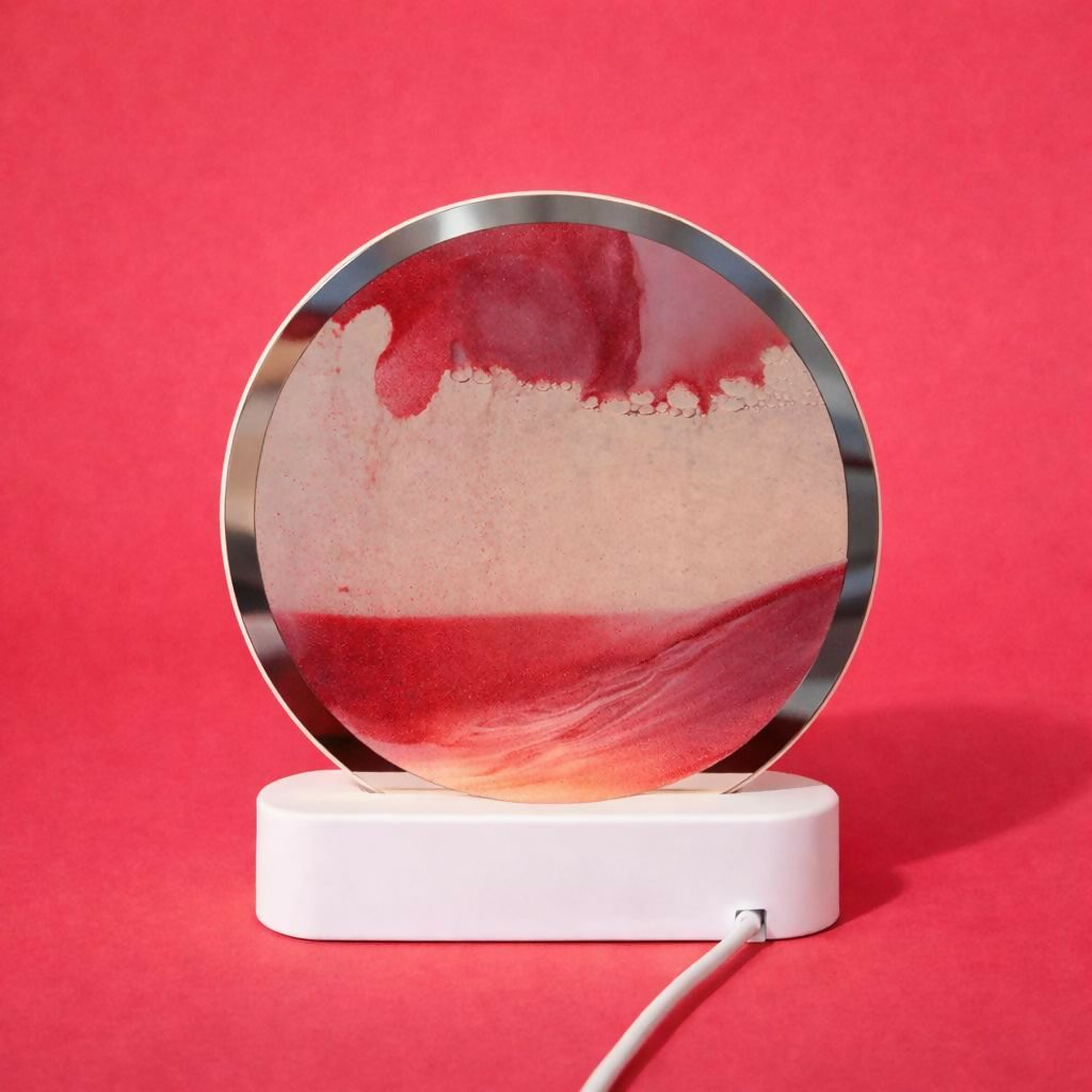 Wukusy round sand art LED table lamp with colorful swirling sand, decorative night light for ambient lighting in a modern home.