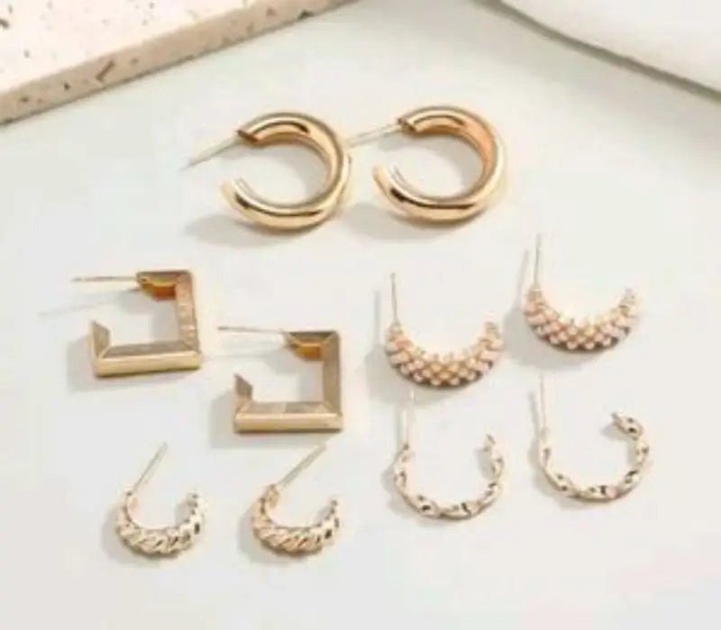 Set of 17 girls' metal stud earrings, including various designs, from Ekom jewelry collection displayed in the image.