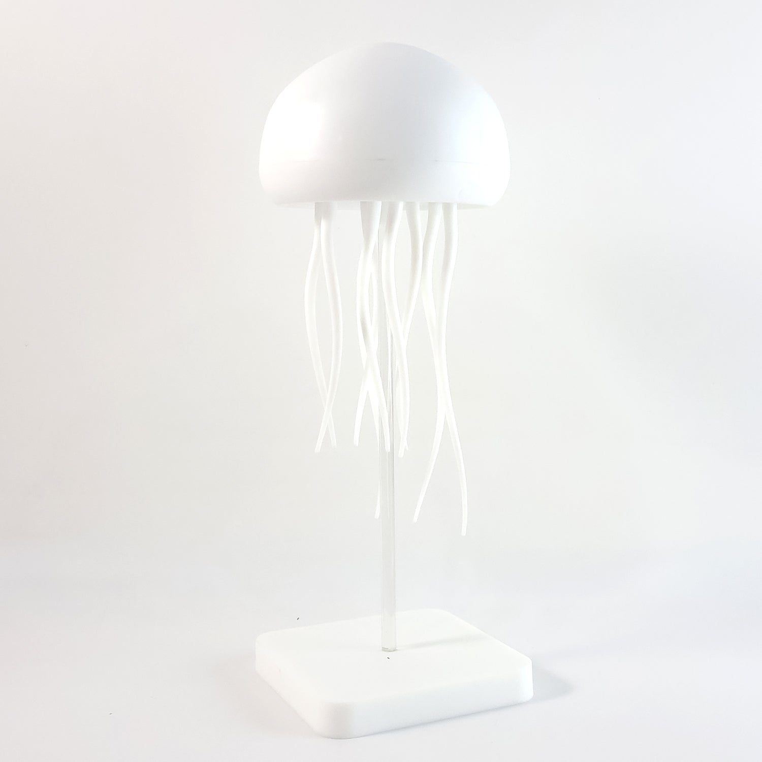 Wukusy jellyfish shape LED mood light lamp with glowing tentacles in a dark room, creating a calming, underwater ambiance.