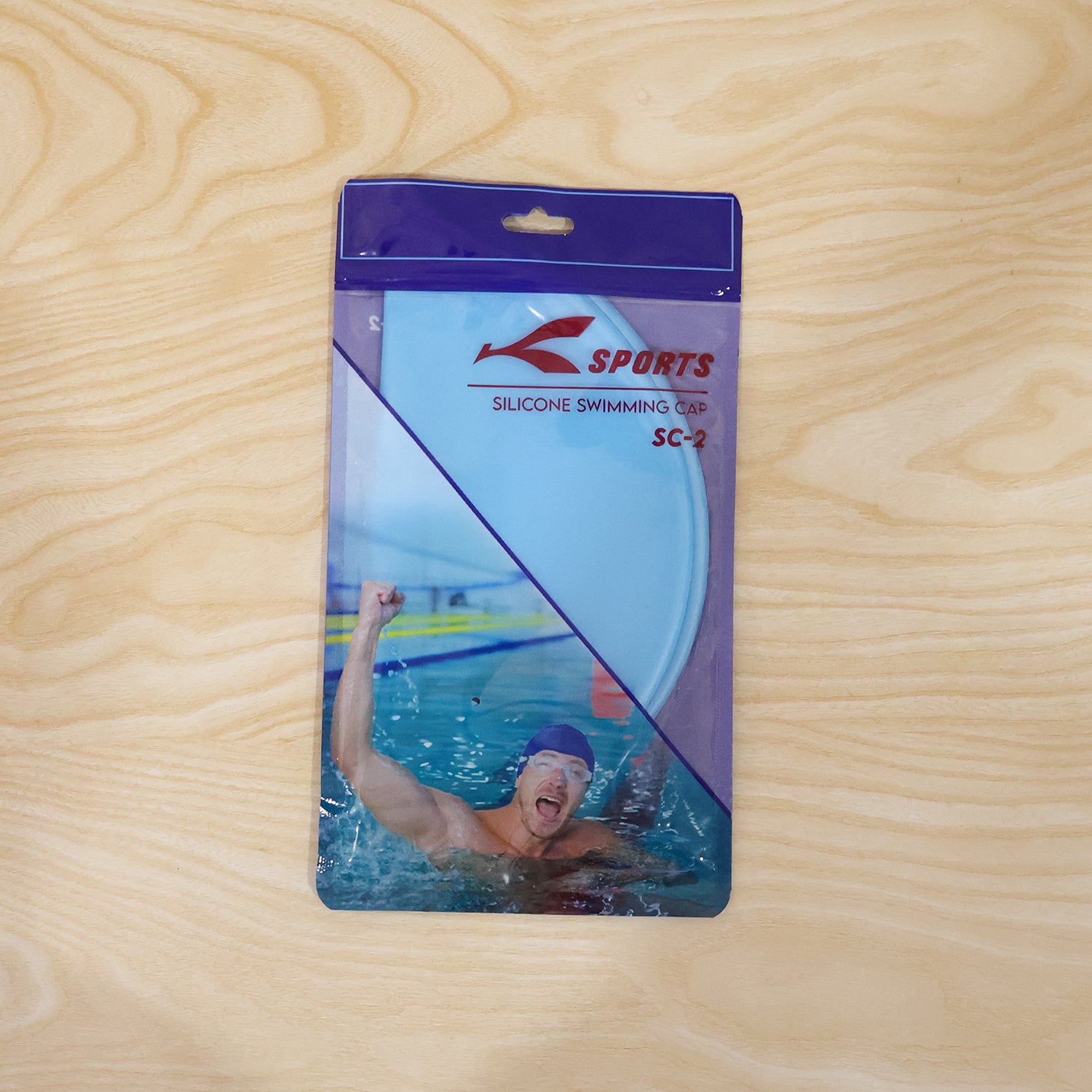Stretchable waterproof silicone swimming cap by Wukusy, shown in bright blue, fits snugly to protect hair during swimming.