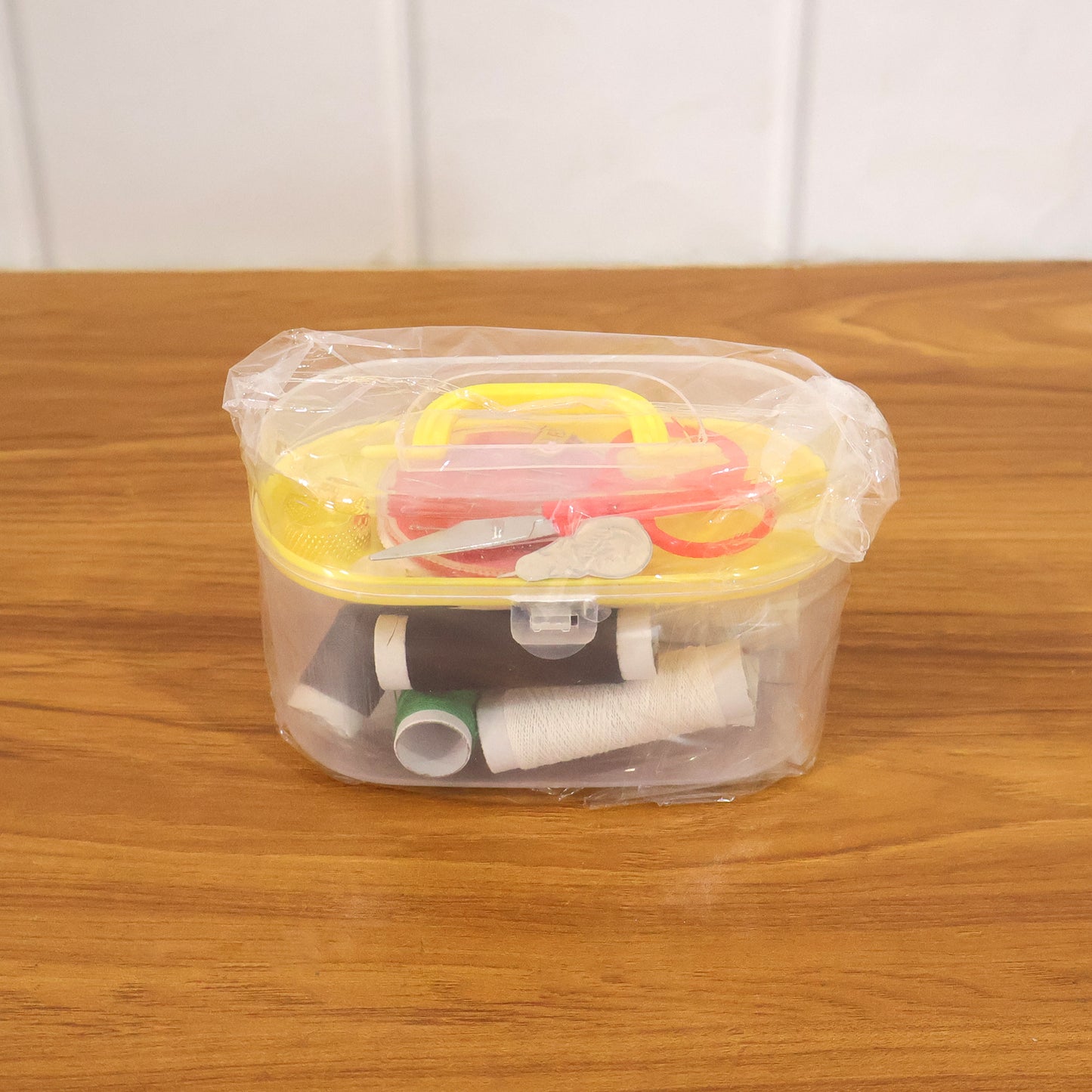 Wukusy multipurpose sewing kit set with needles, threads, scissors, and pins arranged in a compact case for sewing and mending tasks.