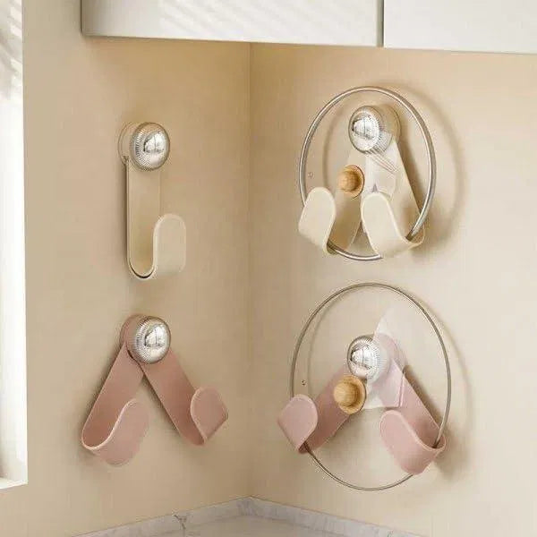 Black pot lid holder with suction cup key holder attached, designed to keep lids organized and secure on smooth surfaces.