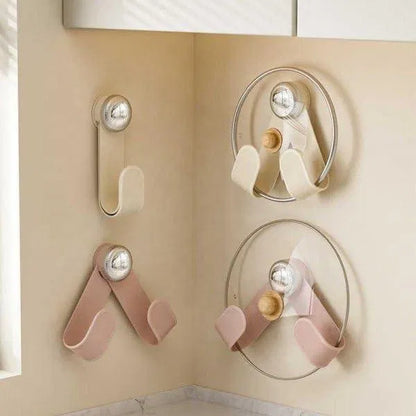 Black pot lid holder with suction cup key holder attached, designed to keep lids organized and secure on smooth surfaces.