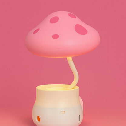 Wukusy Mushroom LED desk lamp with integrated pencil sharpener and USB charging port, in a vibrant color, illuminated on a desk.