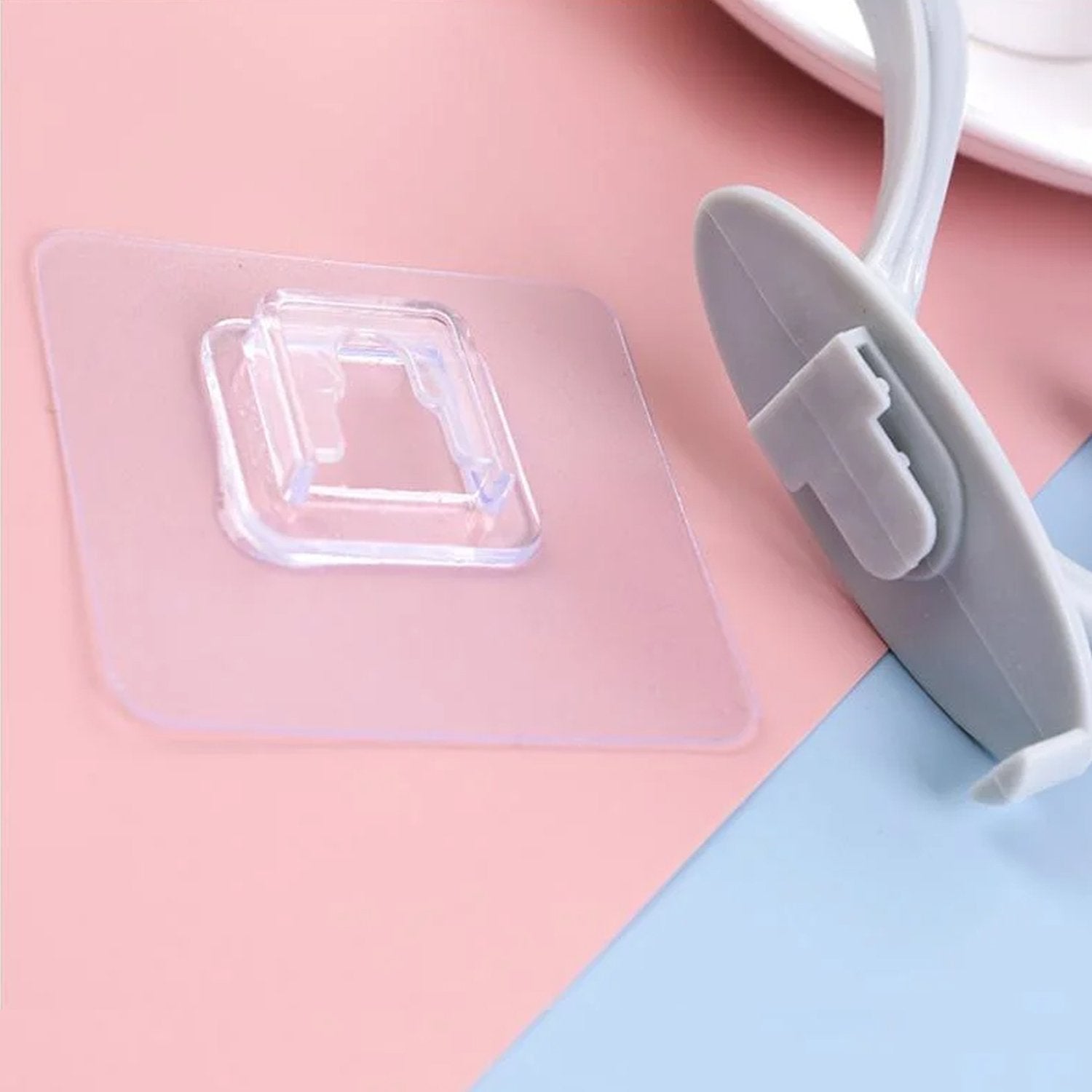 Wukusy self-adhesive plastic wall hook attached to a wall, ideal for home organization and hanging lightweight items.
