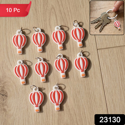 Set of ten Wukusy hot air balloon bag charm keychains with colorful, miniature hot air balloon designs on a white background.