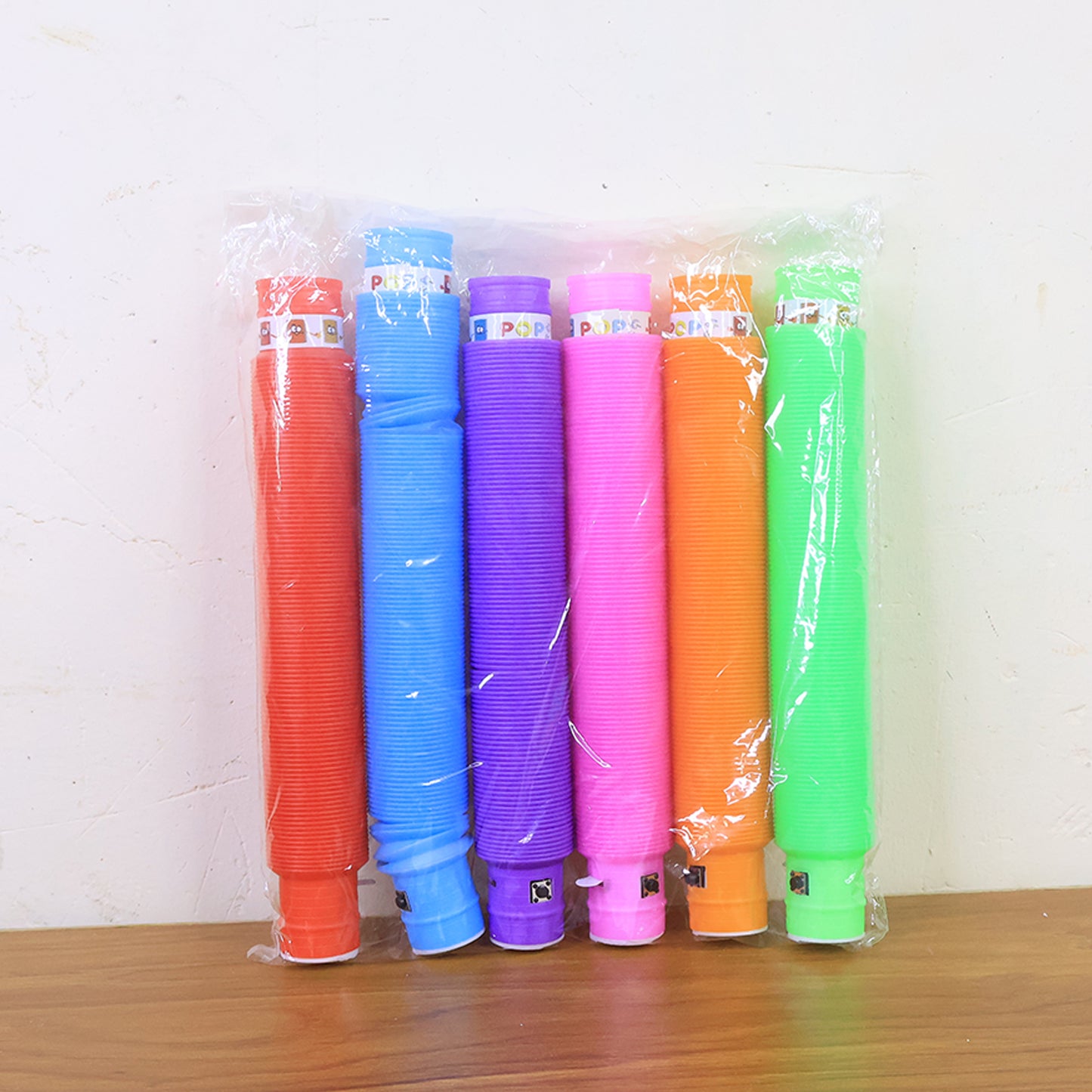 Colorful LED Glow Pop Tube fidget toy by Wukusy, flexible tube with glowing lights for stress relief and sensory play.