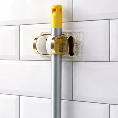 Wall mounted broom and mop holder with strong grip clips by Wukusy, showing secure clips holding cleaning tools in place.