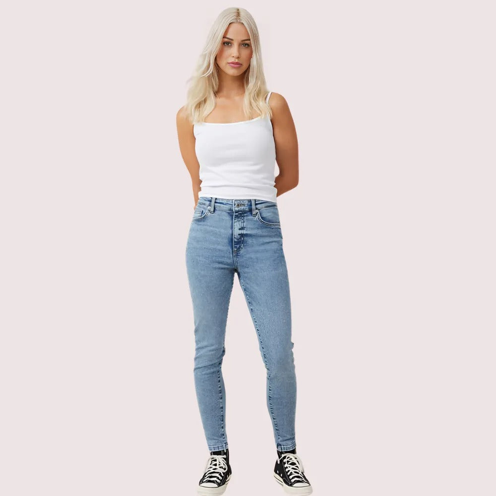 Women's high waist skinny jeans from Snazzyway with perfect curve fit, showcasing a close-up of the denim fabric and fit.