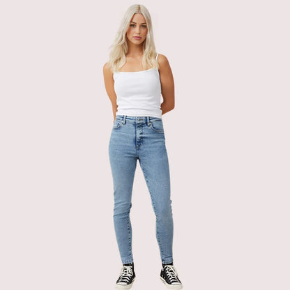 Women's high waist skinny jeans from Snazzyway with perfect curve fit, showcasing a close-up of the denim fabric and fit.