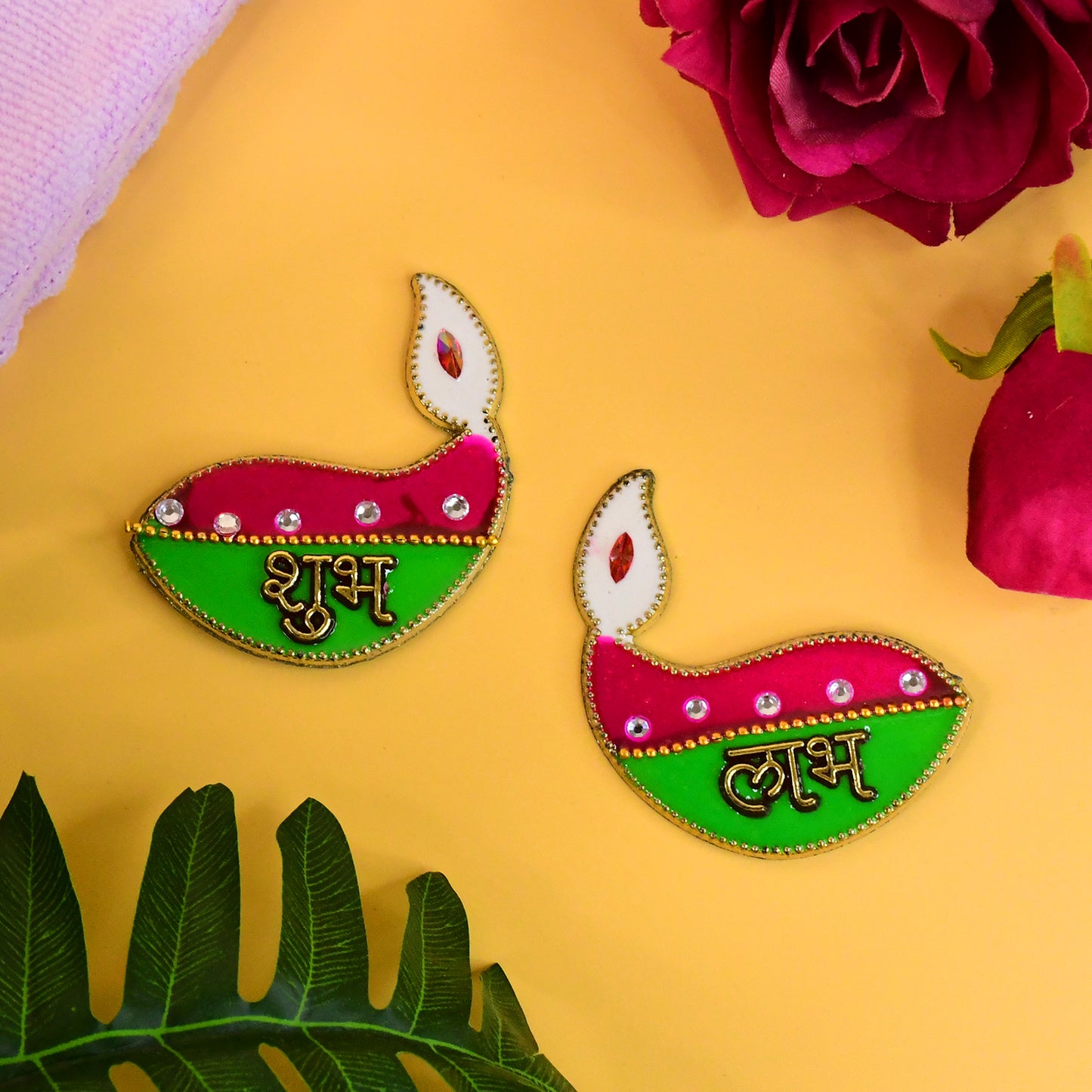 Two Shubh Labh Diya-shaped wall hangings for home decor, featuring intricate design by Wukusy in a decorative display.