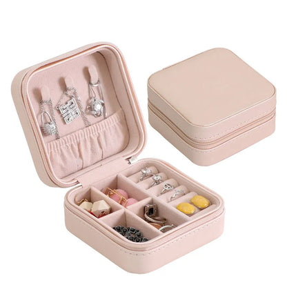 Wukusy mini leather jewelry box for women, portable travel organizer with compartments for rings, earrings, necklaces, and pendants.