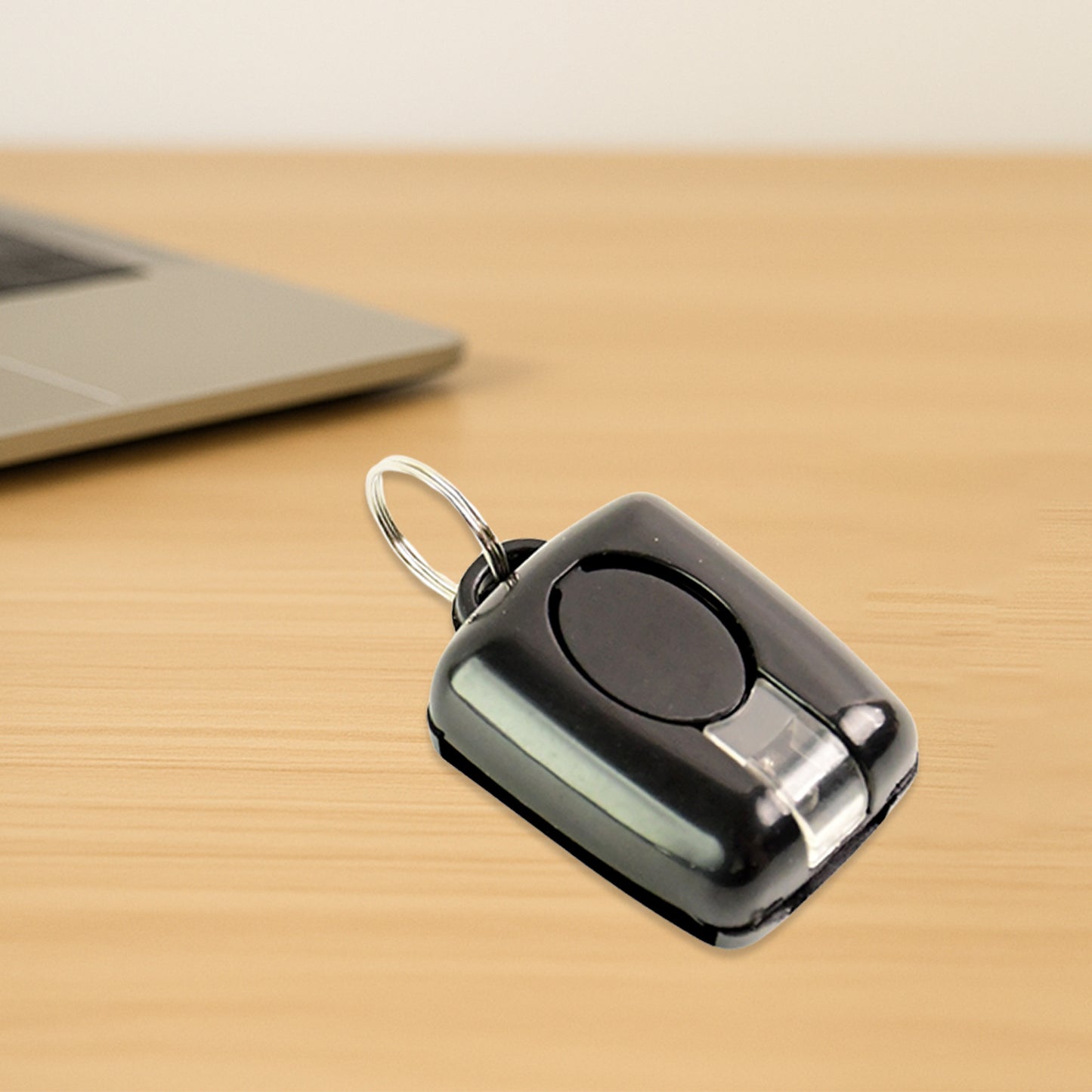 Wukusy Mini LED Torch Keychain with bright light and compact design, attached to a keyring for portable illumination.