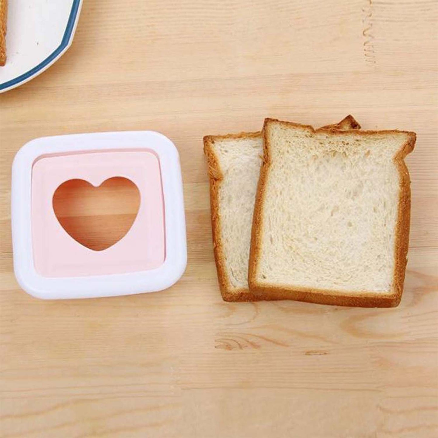 Wukusy heart-shaped sandwich cutter and bread press, made of durable plastic, designed for creating fun sandwiches at home.