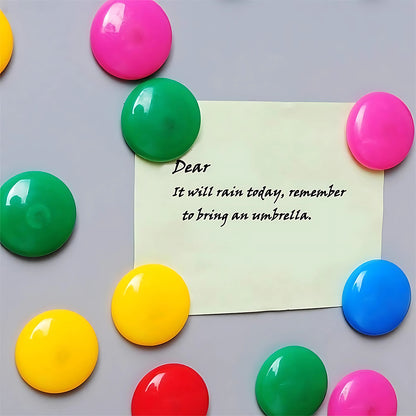 Pink circular plastic magnet with Wukusy branding, designed for office use, featuring a smooth surface and vibrant color.