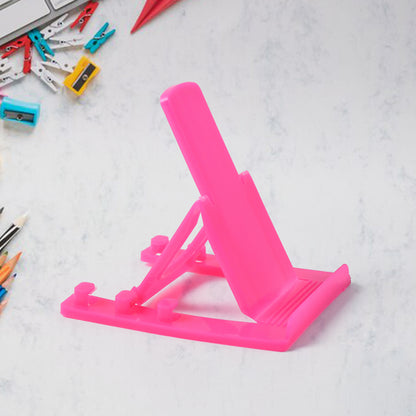 Wukusy adjustable foldable plastic mobile phone stand holder on a desk, showing its compact, portable design for hands-free viewing.