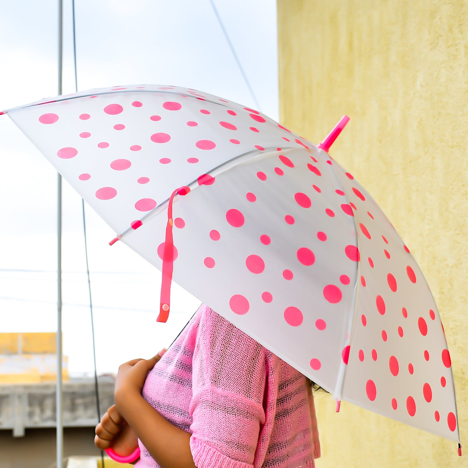 Multicolor dot printed umbrella by Wukusy, suitable for men and women, open to show vibrant dot pattern and sturdy handle.