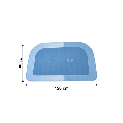 Wukusy super absorbent bathroom floor mat in white, 120x74 cm, lying on tiled bathroom floor soaking water.