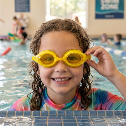 Kids colorful swimming goggles with anti-leak seal and adjustable strap, featuring vibrant blue and yellow accents.