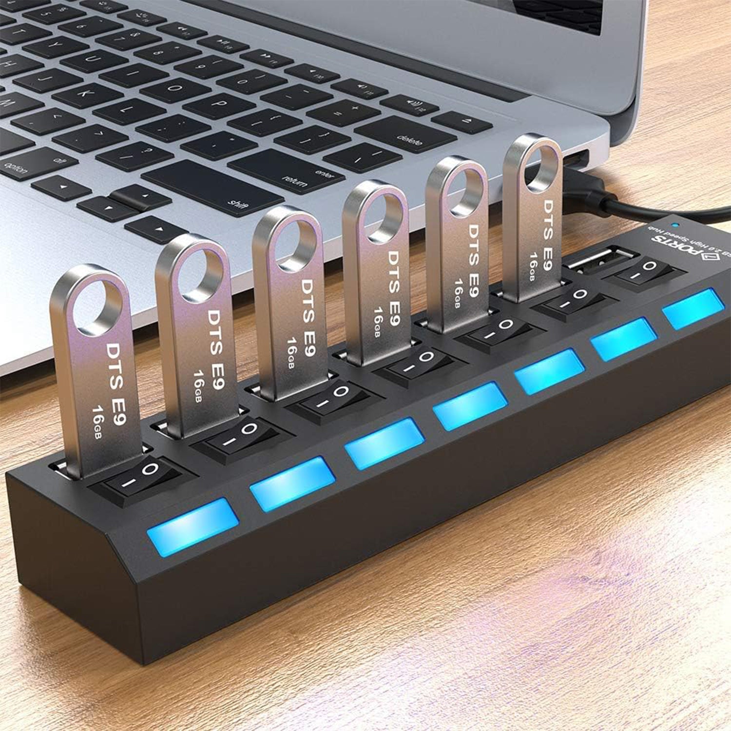 Wukusy 7-port USB 2.0 splitter hub with independent on/off switches, LED indicators, connecting PC, keyboard, laptop, HDD, and camera.