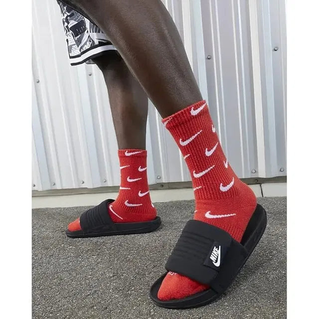 Nike black slides in size 6, casual slippers with a simple design, perfect for comfortable everyday wear.
