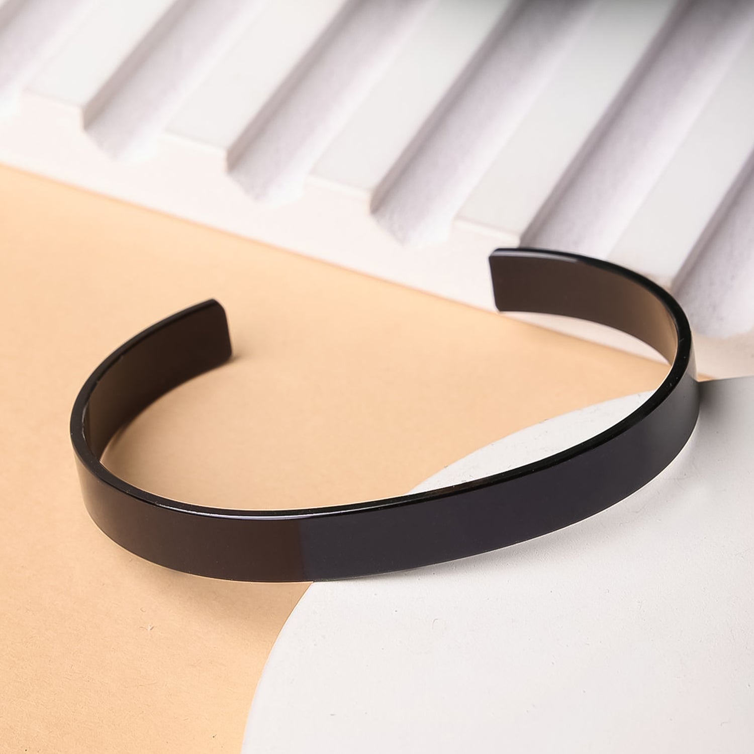 Black-plated stainless steel kada bracelet by Wukusy, stylish fashion accessory featuring a sleek, polished design.